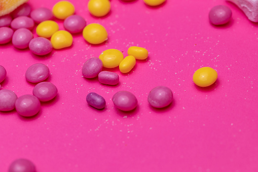 Extreme close up of candy on a bright pink background.