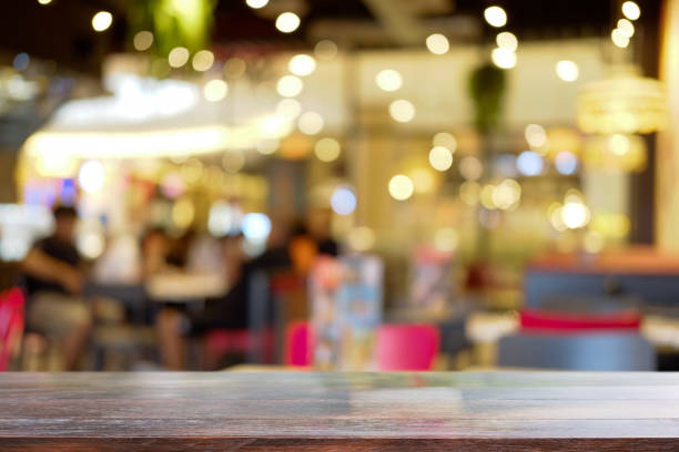 istock Empty wooden table against blurred night market background. Copy space for display or montage your products. 1404622651