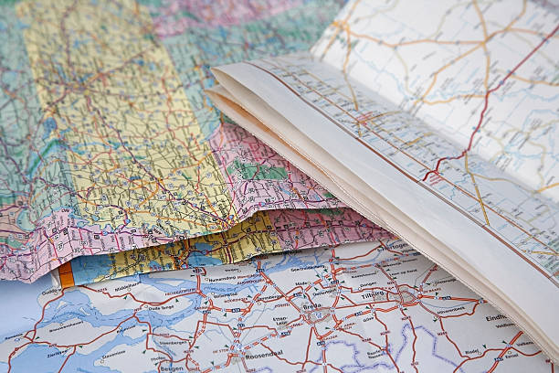 road maps close up of road maps laying on top of each other road map stock pictures, royalty-free photos & images