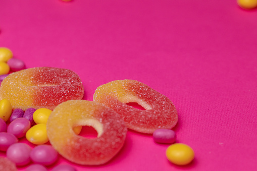 Extreme close up shot of candy on a bright pink background.