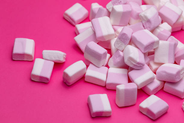 istock Close up marshmallows on a pink background 1404624047