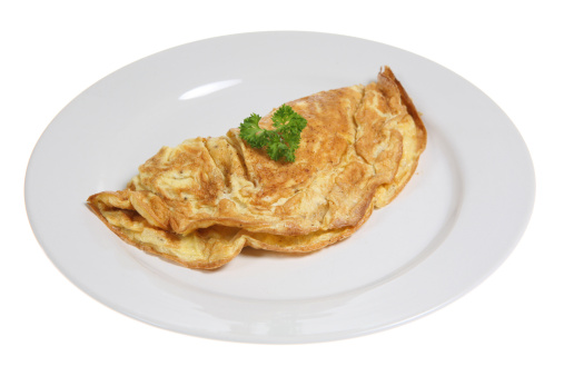 Simple cheese omelet on a white ceramic plate