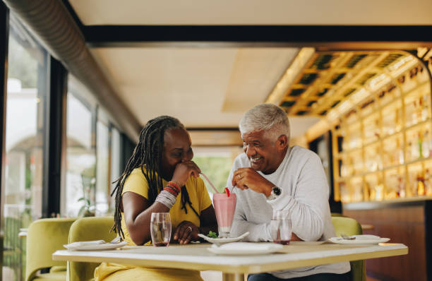 istock Romantic senior couple sharing a delicious milkshake in a cafe 1404626051