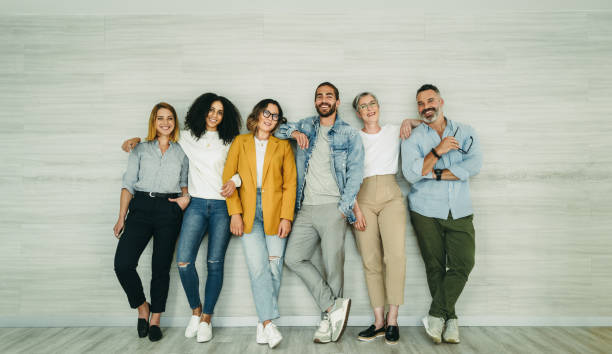 istock Multicultural businesspeople standing against a wall in an office 1404626441