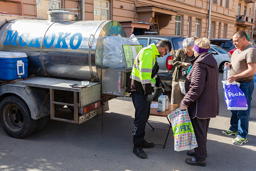 Saint Petersburg-Russia - 14.05.2022: Sale of state farm milk in the courtyard of a residential building.