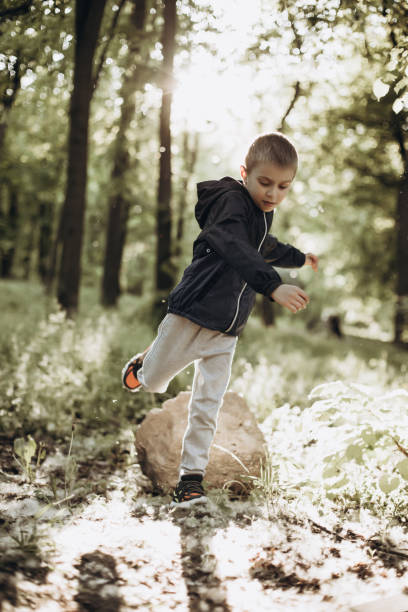 istock Walking boy child in the park on a sunny spring day 1404628405