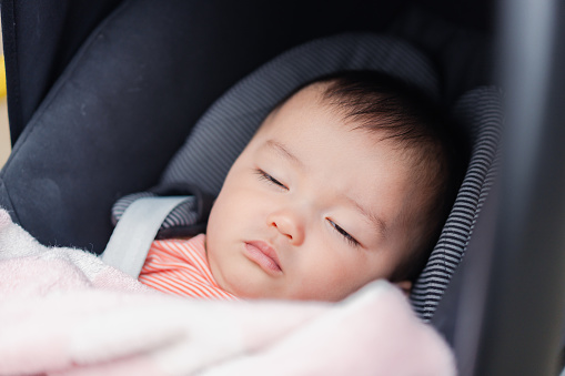 Baby sleeping in a stroller