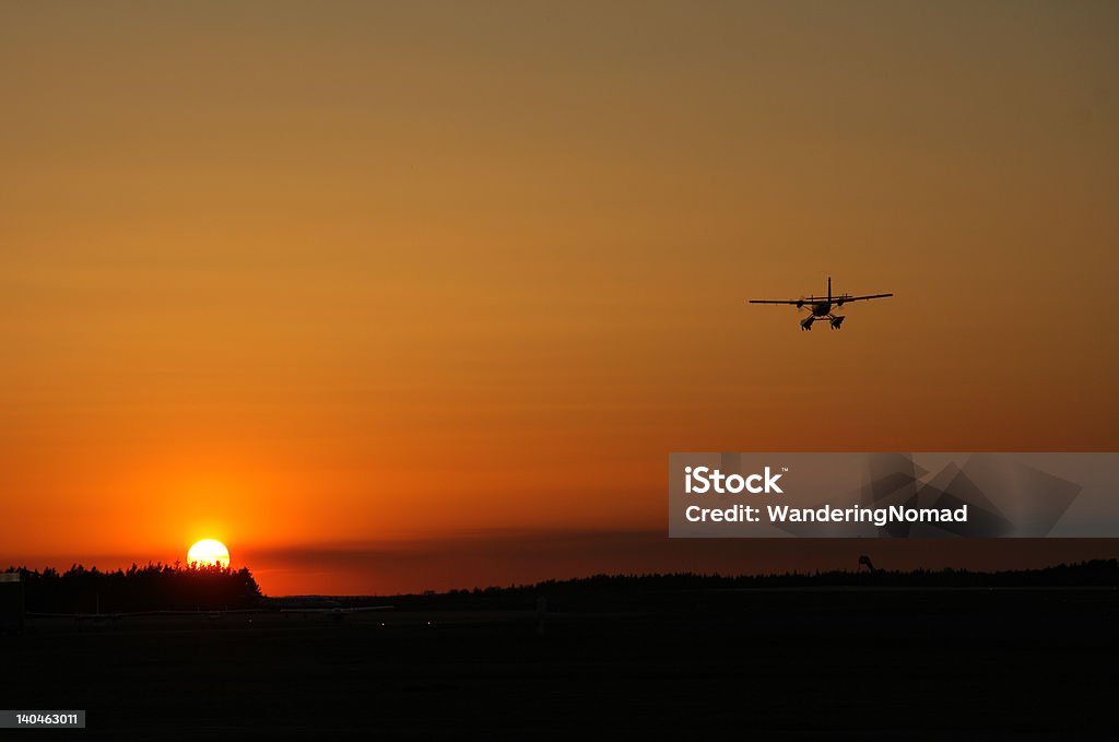 Flying into the Sunset Twin Otter flying into the sunset Sunset Stock Photo