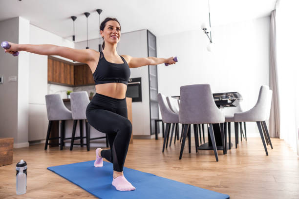 istock Young sporty woman with dumbbells 1404630129