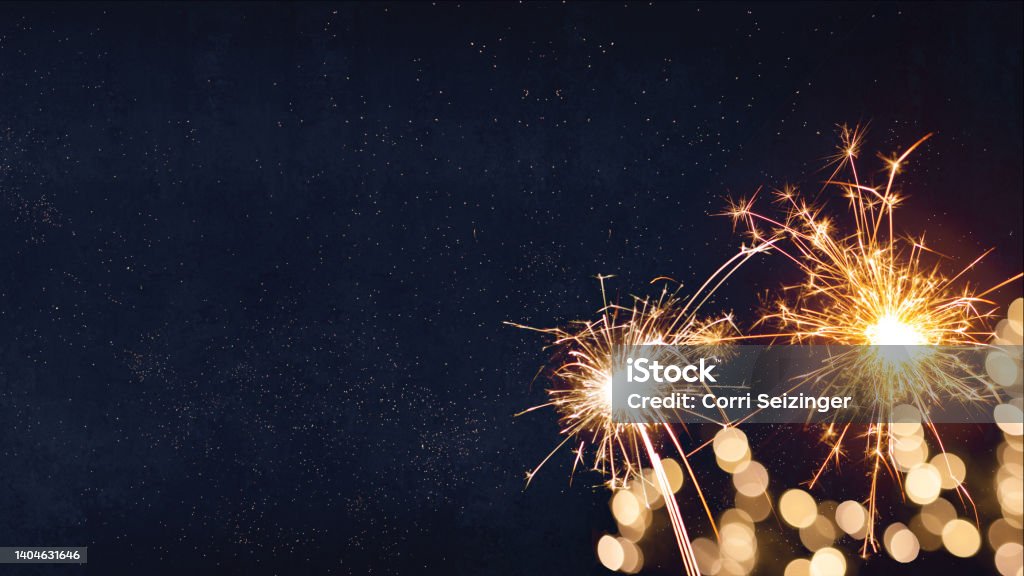 Silvester, New Year's Eve 2023 Party, New year, Fireworks, Firework background banner panorama long- Sparklers and bokeh lights on dark blue night sky Silvester, New Year's Eve 2023 Party, New year, Fireworks, Firework holiday celebration background banner panorama long greeting card - Sparklers and bokeh lights on dark blue night sky New Year's Eve Stock Photo