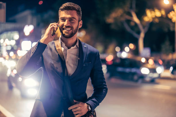 istock Manager using his smart phone outdoor at night 1404631963