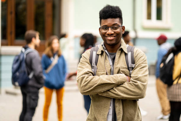istock Young African-American student standing in front of the University 1404632082