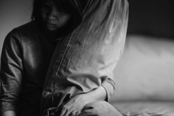 istock A young woman suffering from depression sits alone in her room. 1404633343