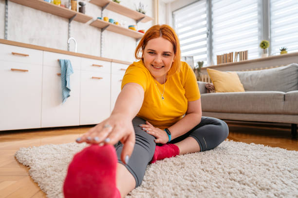istock Young Overweight Woman Stretching Before Exercising 1404634495