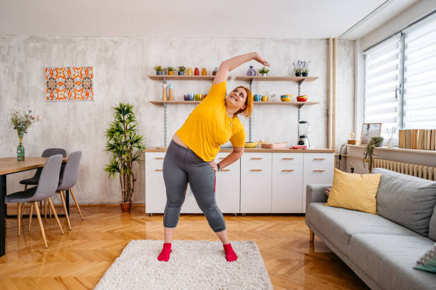 istock Young Overweight Woman Stretching Before Exercising 1404635362