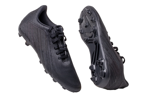 Primer plano de un par de botas de fútbol de cuero negro aisladas sobre fondo blanco. Zapatillas de entrenamiento al aire libre para niños de atletismo profesional. Calzado deportivo. photo
