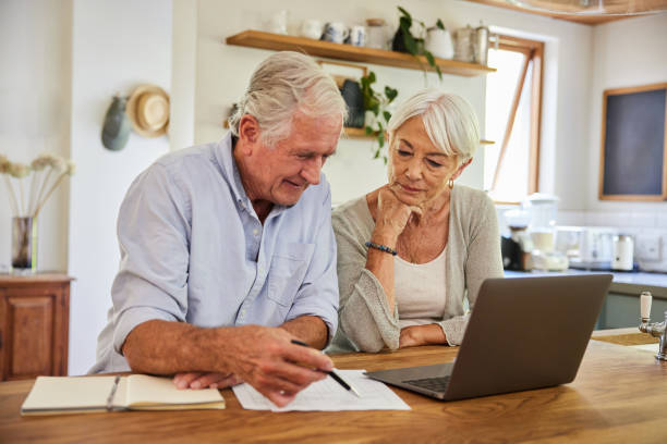 istock Senior couple using a laptop and going over their home finances 1404636094