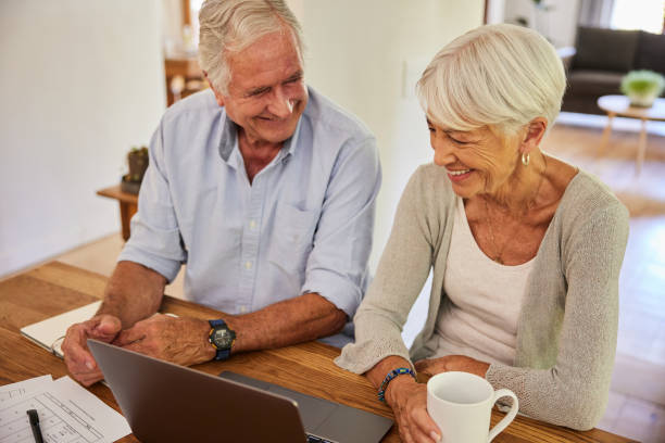 istock Senior couple laughing while going over their home finances together 1404636852