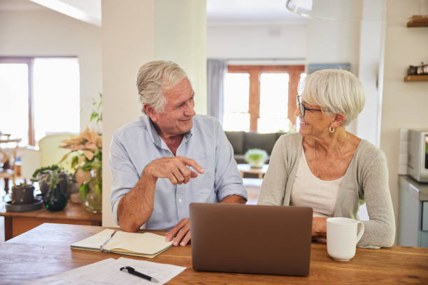 istock Senior couple smiling while going over their home finances together 1404636898