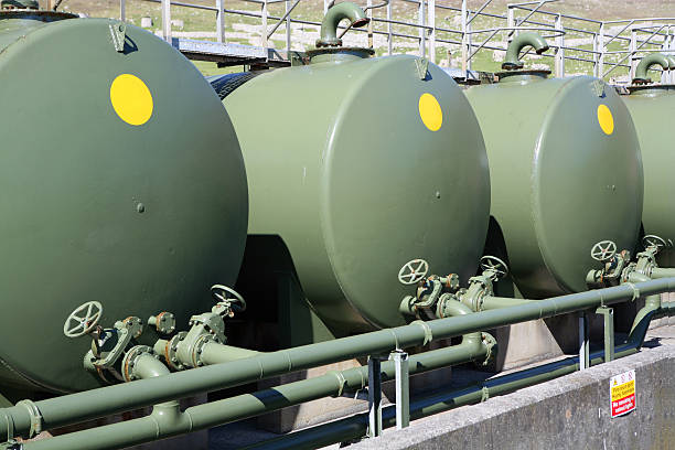 Three large green outdoor fuel tanks Fuel oil tanks, with connecting pipework and gate valve isolators, painted in military green fuel storage tank gasoline army military stock pictures, royalty-free photos & images