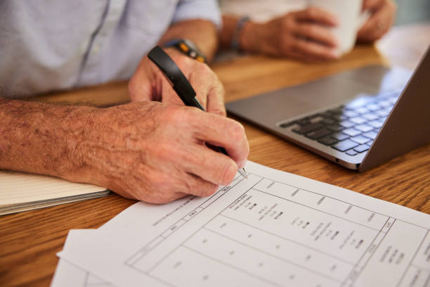 istock Senior man signing a medicare bill while going over finances with his wife 1404637639