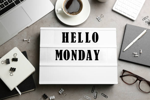 istock Hello Monday, start your week with good mood. Flat lay composition with lightbox and office supplies on grey table 1404638833