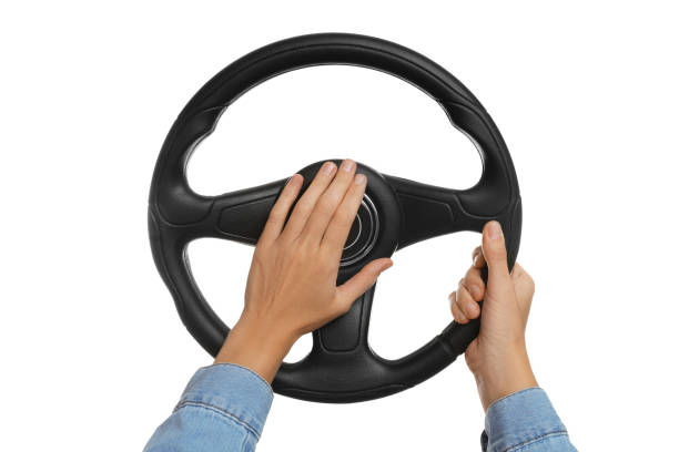 istock Woman with steering wheel on white background, closeup 1404639015