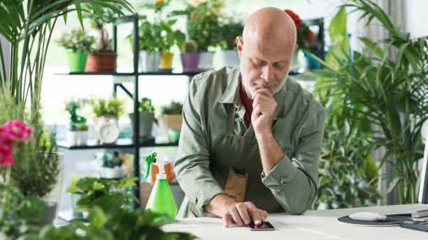 istock Professional florist taking orders on his smartphone 1404639142