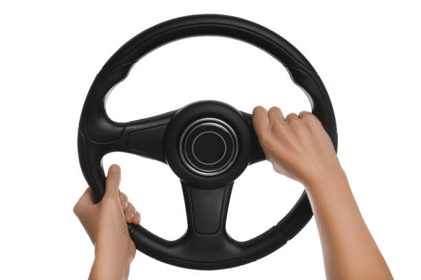 istock Woman with steering wheel on white background, closeup 1404639182