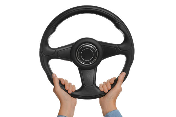 istock Woman with steering wheel on white background, closeup 1404639185