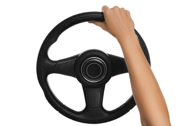 Woman with steering wheel on white background, closeup