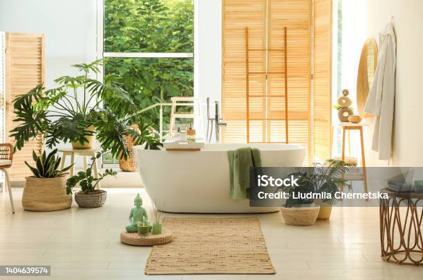 Stylish Bathroom Interior With Modern Tub Window And Beautiful Houseplants Home Design Stock Photo - Download Image Now