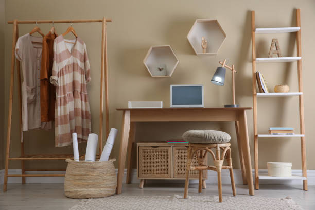 istock Comfortable wooden stool near table with laptop indoors. Interior design 1404639588