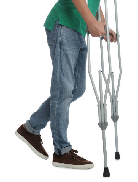man with injured leg using crutches on white background, closeup - physical injury men orthopedic equipment isolated on white imagens e fotografias de stock