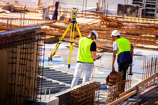 Surveyors at the construction site using GPS mapping.  GPS for Land Surveying. GNSS and GPS Survey Equipment.