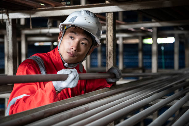 istock Chinese Male Worker moving metal pole 1404640835