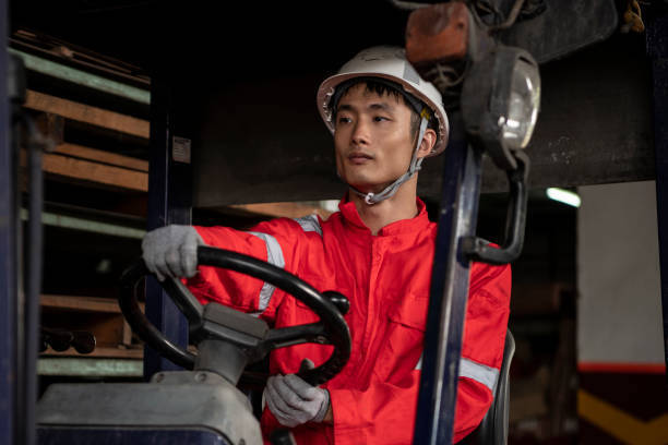Factory worker driving forklift stock photo