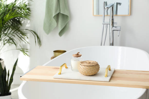 istock Tray with wicker box and candle on tub in bathroom. Interior design 1404641194