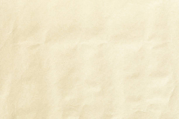istock Crumpled brown background paper sheet texture 1404643463