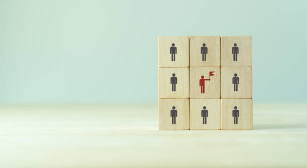 istock Team building and leadership concept. Work collaboration for achieving goal and successful business. Productive people skills. Hand placed wooden cubes with team leader icon. Human resource management 1404643512