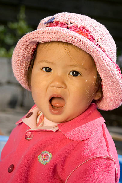 little girl with pink hat stock photo