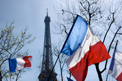 French flags with Eiffel Tower in background