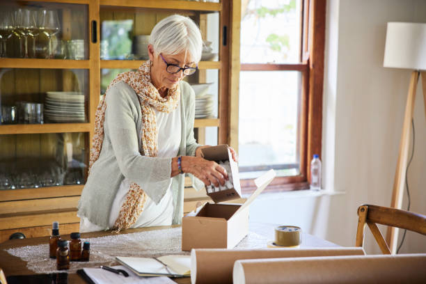 istock Senior woman placing online orders in boxes in her store 1404645683