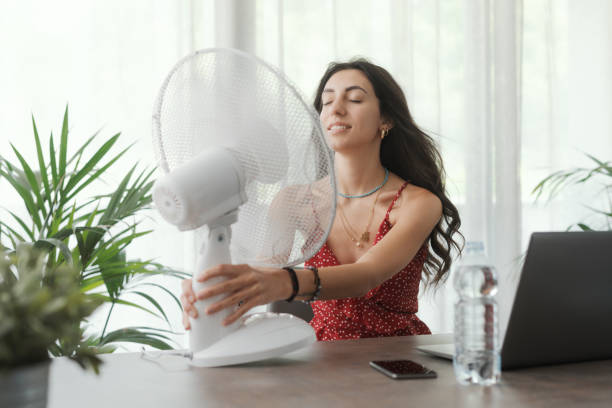 istock Woman cooling herself at home 1404646118