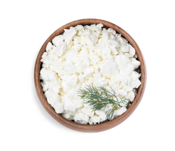 istock Fresh cottage cheese with dill in bowl isolated on white, top view 1404646205