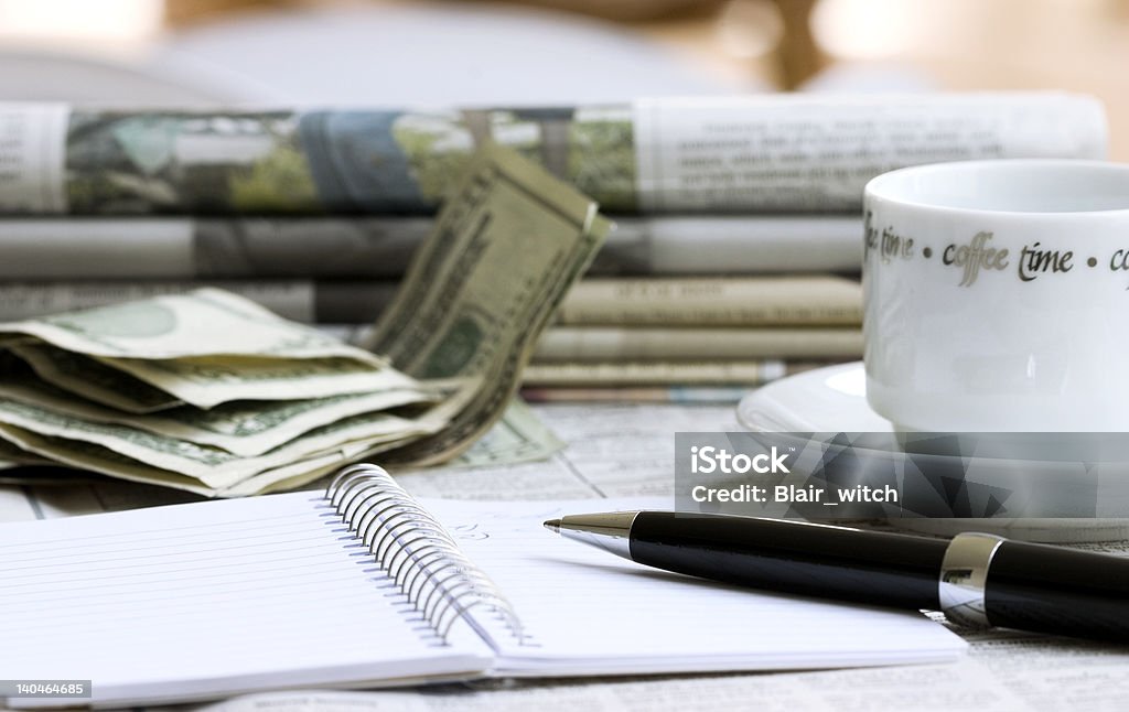 Morning business still life Notebook with pen, money, newspapers and cup of coffee Advertisement Stock Photo