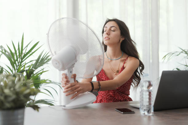 istock Woman cooling herself at home 1404646972