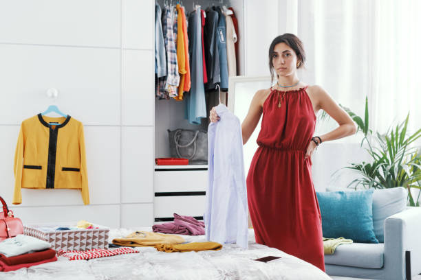 istock Woman choosing clothes in her bedroom 1404646990