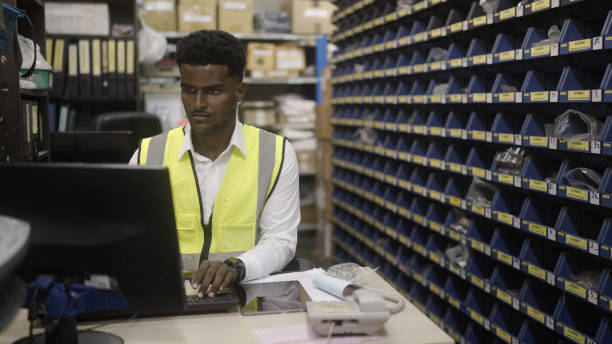 istock Black worker is checking the goods in the warehouse. 1404647121