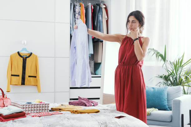 istock Woman choosing clothes in her bedroom 1404647635